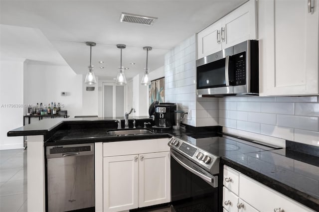 770 Claughton Island Dr Unit 1114, Miami, FL 33131 - kitchen featuring stainless steel appliances, a peninsula, white cabinets, and backsplash