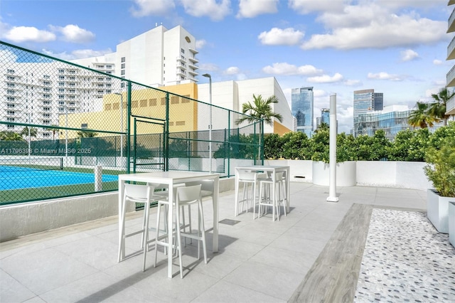 770 Claughton Island Dr Unit 1114, Miami, FL 33131 - view of patio with a city view and a tennis court