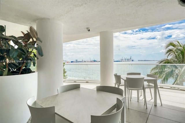 770 Claughton Island Dr Unit 1114, Miami, FL 33131 - dining room with a water view, a textured ceiling, and plenty of natural light