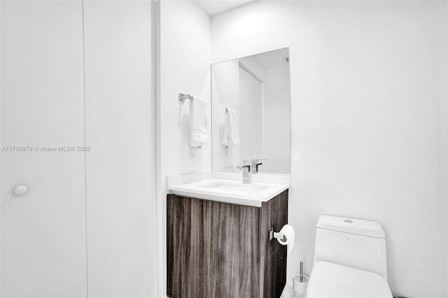 bathroom with toilet and vanity