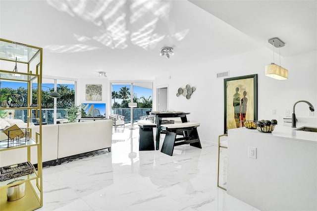 interior space with a sink, marble finish floor, and visible vents