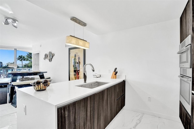 488 NE 18th St Unit 208, Miami, FL 33132 - kitchen with modern cabinets, light marble finish flooring, dark brown cabinets, light countertops, and a peninsula