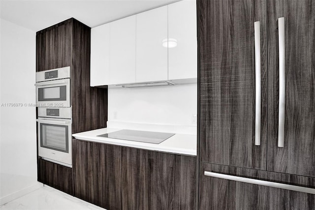 488 NE 18th St Unit 208, Miami, FL 33132 - kitchen with modern cabinets, dark brown cabinetry, light countertops, black electric cooktop, and white cabinetry