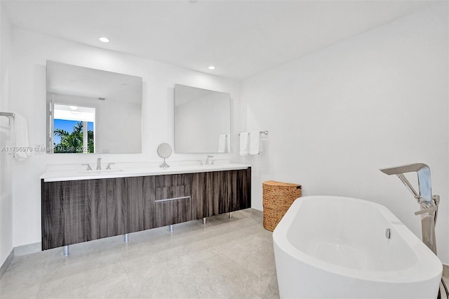 488 NE 18th St Unit 208, Miami, FL 33132 - full bathroom featuring double vanity, a freestanding bath, marble finish floors, and recessed lighting