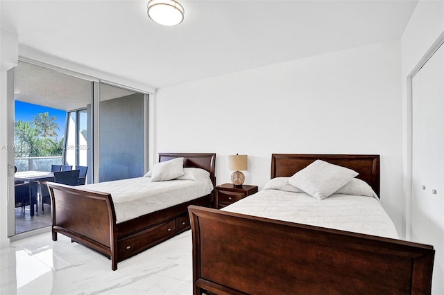 488 NE 18th St Unit 208, Miami, FL 33132 - bedroom featuring light marble finish flooring and access to exterior