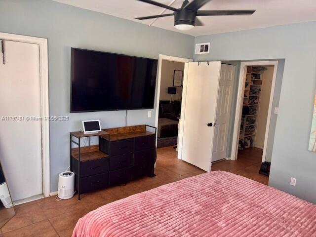 tiled bedroom featuring ceiling fan and visible vents