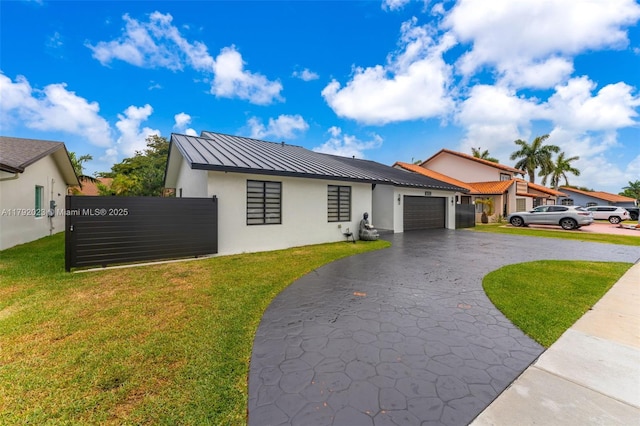 13211 SW 6th St, Miami, FL 33184 - view of front facade featuring metal roof, aphalt driveway, stucco siding, and a standing seam roof
