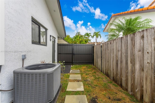 13211 SW 6th St, Miami, FL 33184 - view of yard featuring cooling unit, a gate, and a fenced backyard