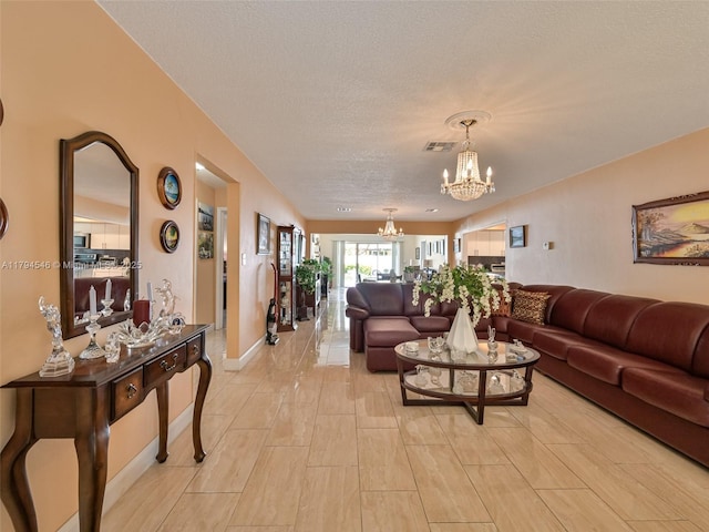 104 N 31st Ct, Hollywood, FL 33021 - living room with a chandelier, a textured ceiling, baseboards, and visible vents