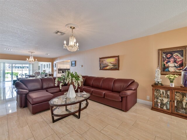 104 N 31st Ct, Hollywood, FL 33021 - living room with a textured ceiling, a chandelier, and visible vents