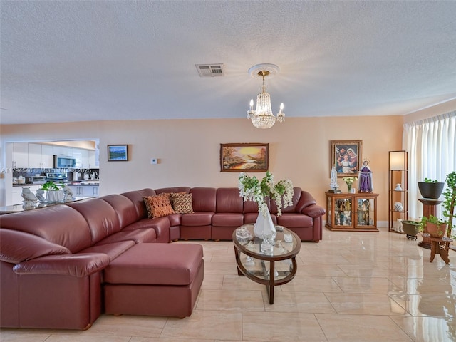 104 N 31st Ct, Hollywood, FL 33021 - living room with a chandelier, visible vents, and a textured ceiling