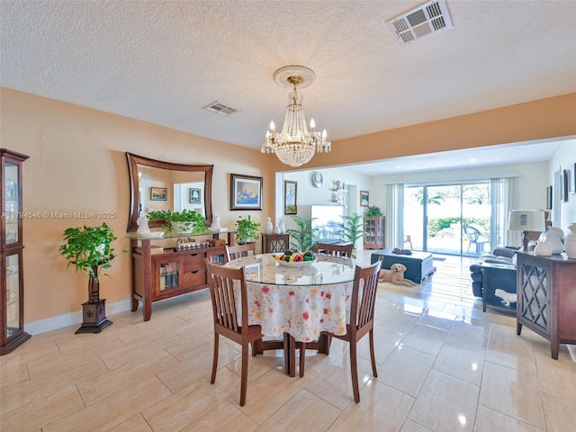 104 N 31st Ct, Hollywood, FL 33021 - dining space featuring a chandelier, a textured ceiling, visible vents, and baseboards