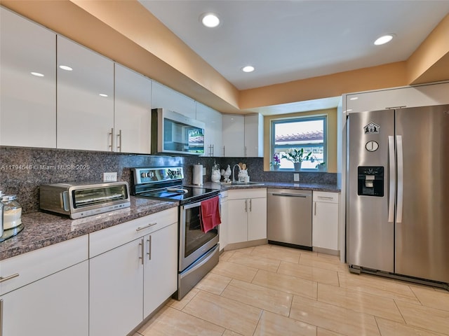 104 N 31st Ct, Hollywood, FL 33021 - kitchen featuring a sink, a toaster, white cabinetry, decorative backsplash, and appliances with stainless steel finishes