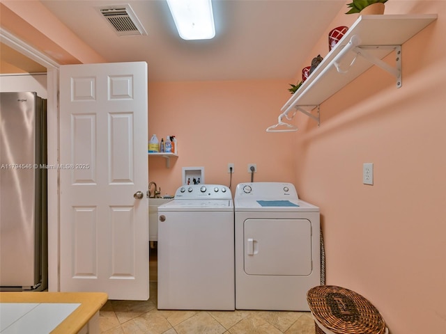 104 N 31st Ct, Hollywood, FL 33021 - washroom with laundry area, light tile patterned flooring, separate washer and dryer, and visible vents