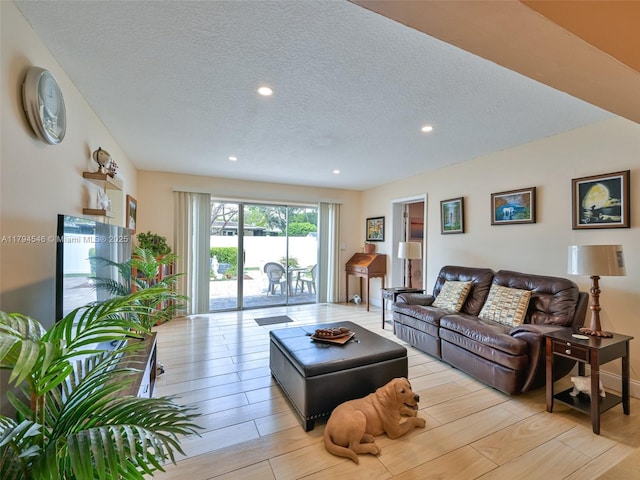 104 N 31st Ct, Hollywood, FL 33021 - living room featuring light wood finished floors, a textured ceiling, and recessed lighting