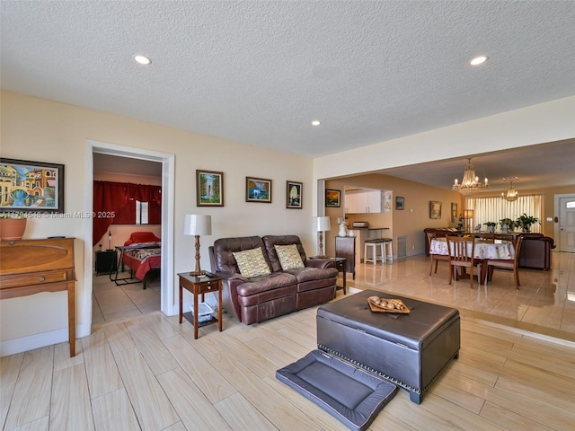 104 N 31st Ct, Hollywood, FL 33021 - living room featuring a chandelier, a textured ceiling, and recessed lighting