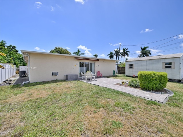 104 N 31st Ct, Hollywood, FL 33021 - rear view of house featuring a lawn, a patio, stucco siding, and fence