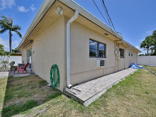 104 N 31st Ct, Hollywood, FL 33021 - view of property exterior with a yard, a patio area, stucco siding, and fence