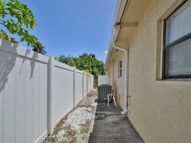 104 N 31st Ct, Hollywood, FL 33021 - view of side of home with fence, stucco siding, and central AC