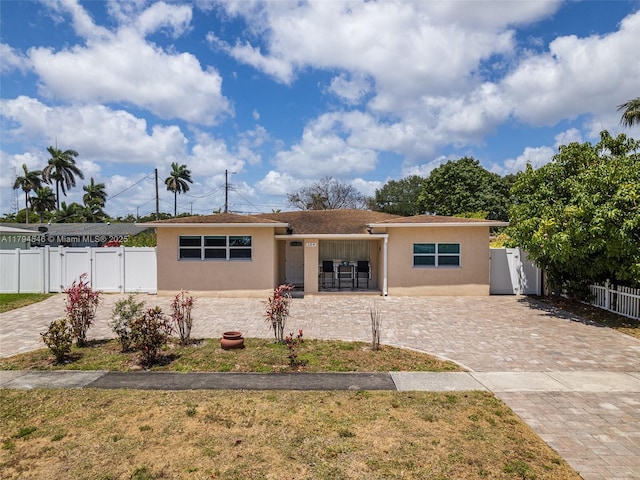 104 N 31st Ct, Hollywood, FL 33021 - single story home with decorative driveway, stucco siding, fence, and a gate