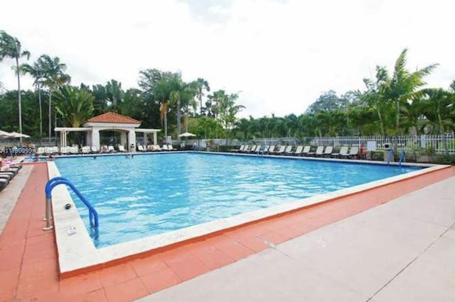 pool featuring a patio area and fence