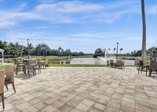 view of patio featuring outdoor dining area and a water view