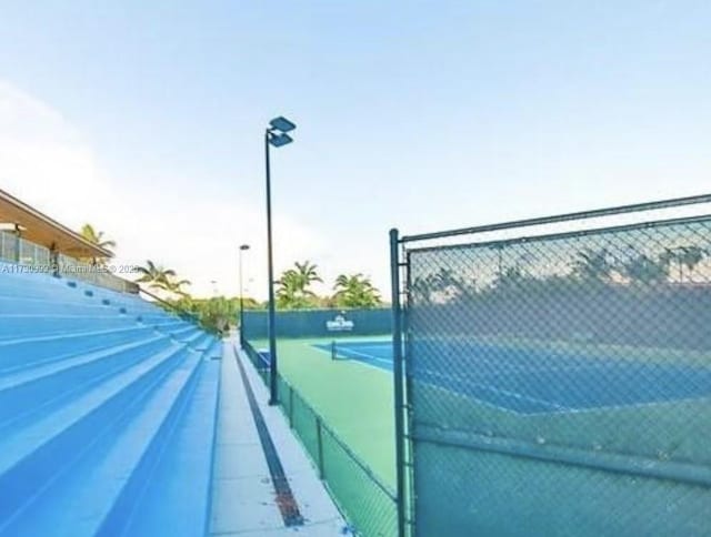 view of tennis court with fence