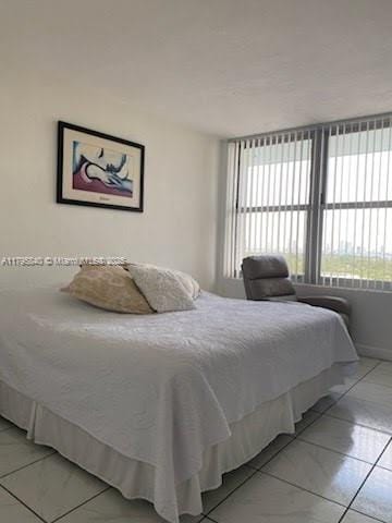 bedroom with light tile patterned floors