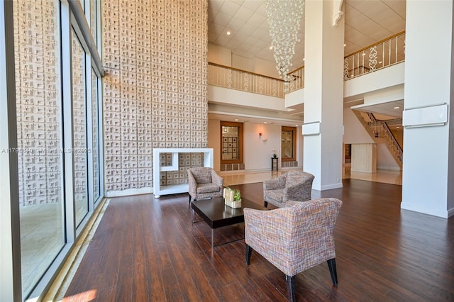 2899 Collins Ave Unit 1738, Miami Beach, FL 33140 - living area featuring a high ceiling, wood finished floors, baseboards, stairway, and a chandelier