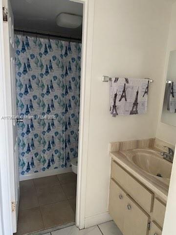 2899 Collins Ave Unit 1738, Miami Beach, FL 33140 - full bath with vanity, tile patterned floors, baseboards, and curtained shower