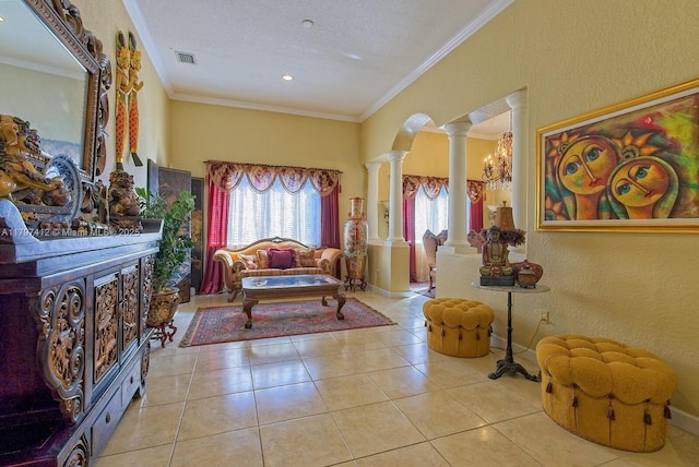 living area with crown molding, ornate columns, visible vents, and tile patterned flooring