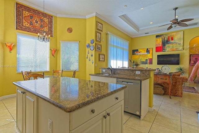 kitchen with stainless steel dishwasher, crown molding, a kitchen island, and light tile patterned floors