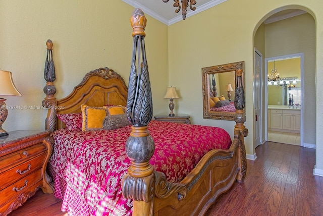 bedroom with crown molding, a chandelier, wood finished floors, and arched walkways