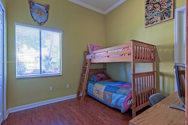 bedroom featuring baseboards, ornamental molding, and wood finished floors