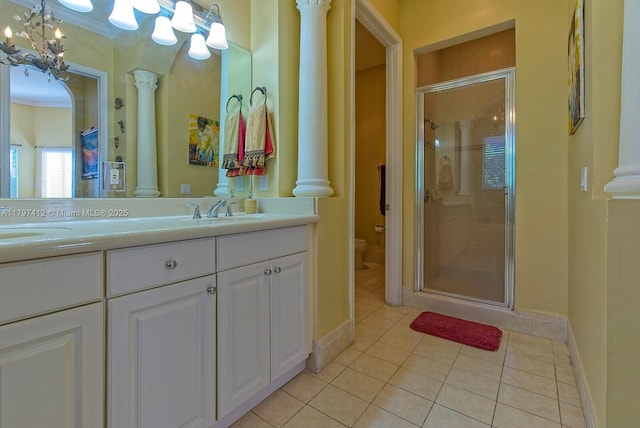 full bath featuring toilet, tile patterned floors, a sink, and ornate columns