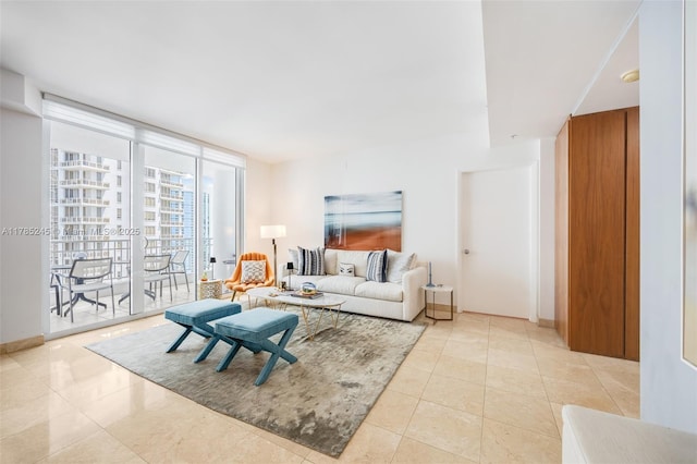 living area featuring expansive windows and light tile patterned flooring