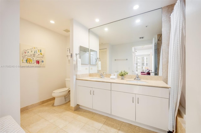 full bath with a sink, double vanity, toilet, and visible vents