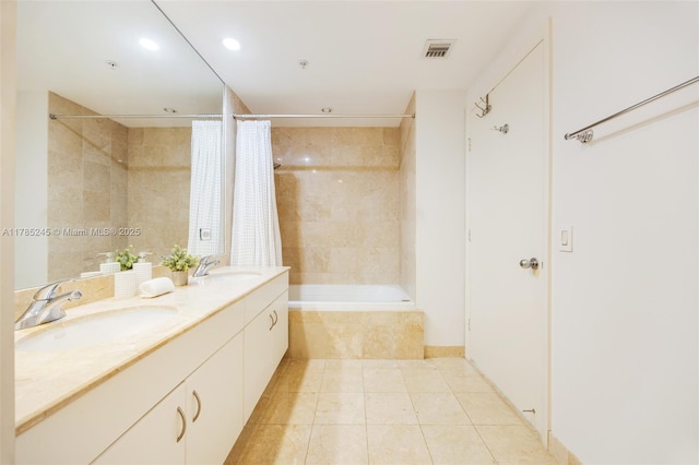 full bath featuring double vanity, tile patterned floors, visible vents, and a sink