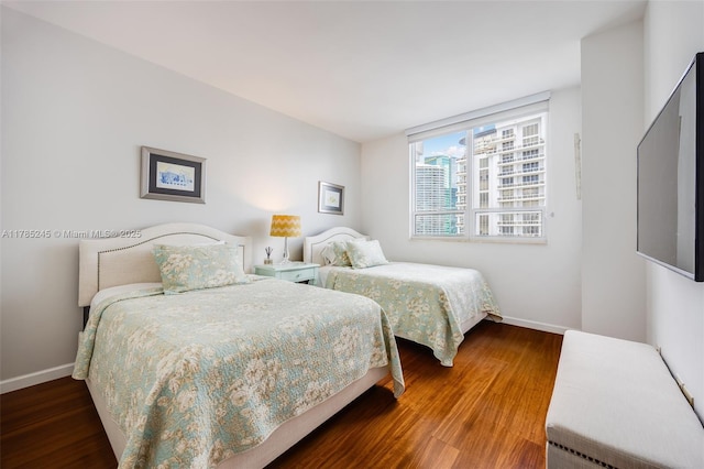 bedroom with wood finished floors and baseboards