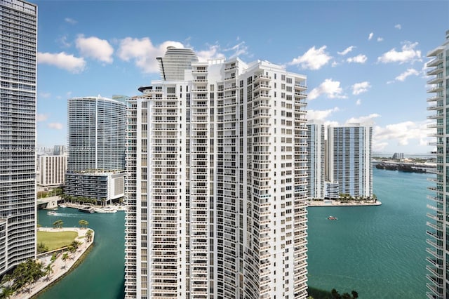 exterior space with a city view and a water view