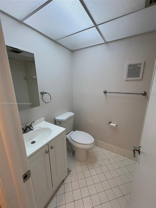 bathroom featuring toilet, visible vents, tile patterned flooring, and vanity