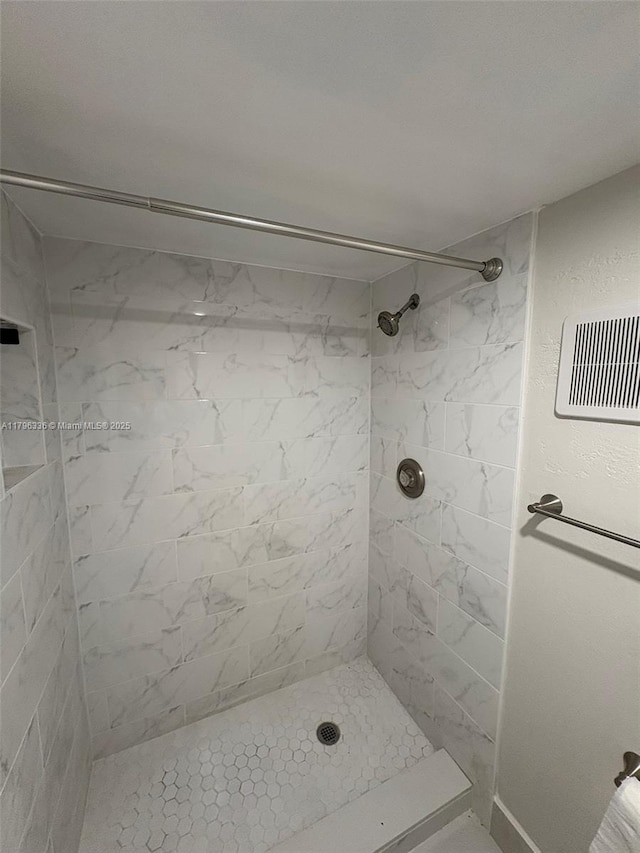 full bath featuring tiled shower