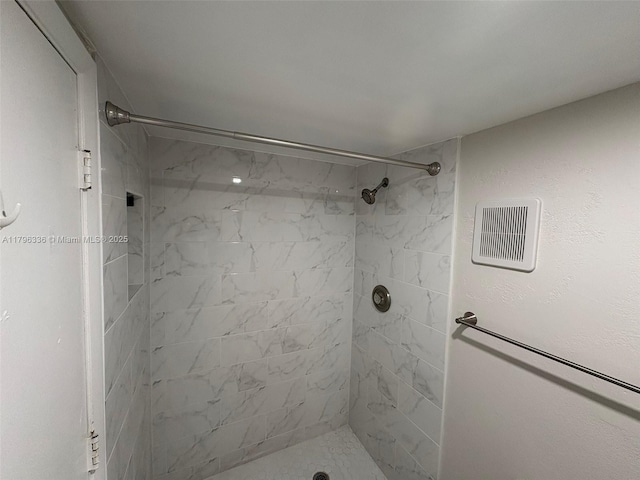 full bathroom featuring a shower stall and visible vents