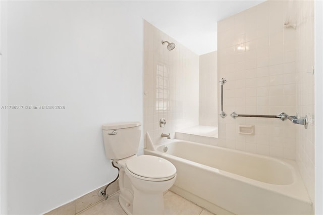bathroom featuring toilet, tub / shower combination, tile patterned flooring, and baseboards