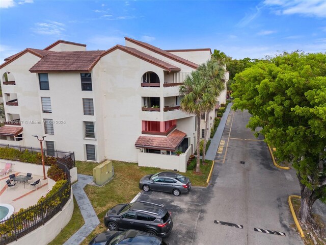 9040 SW 125th Ave Unit D202, Miami, FL 33186 - view of building exterior featuring fence and uncovered parking