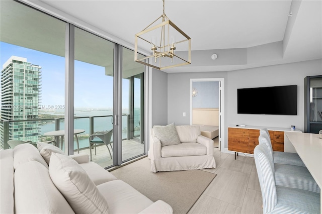living room with a wall of windows and a notable chandelier