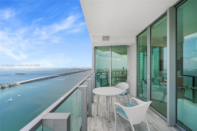 balcony with a water view and visible vents
