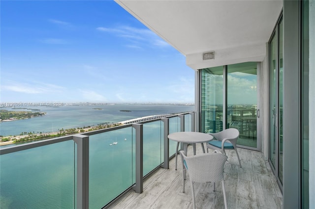 balcony with a water view and visible vents