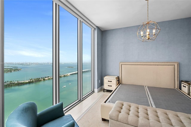 tiled bedroom with a water view and a notable chandelier