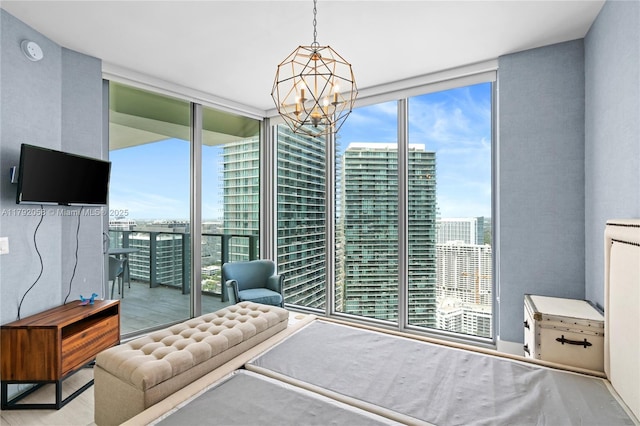 bedroom featuring an inviting chandelier and floor to ceiling windows
